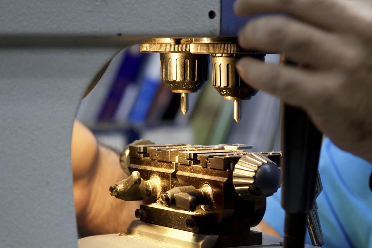 A key being cut on a key-cutting machine, the original and the blank clamped side by side