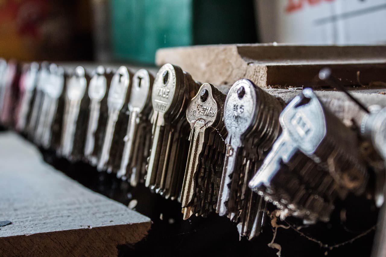 Key blanks lined up along a shelf in a key-cutting shop