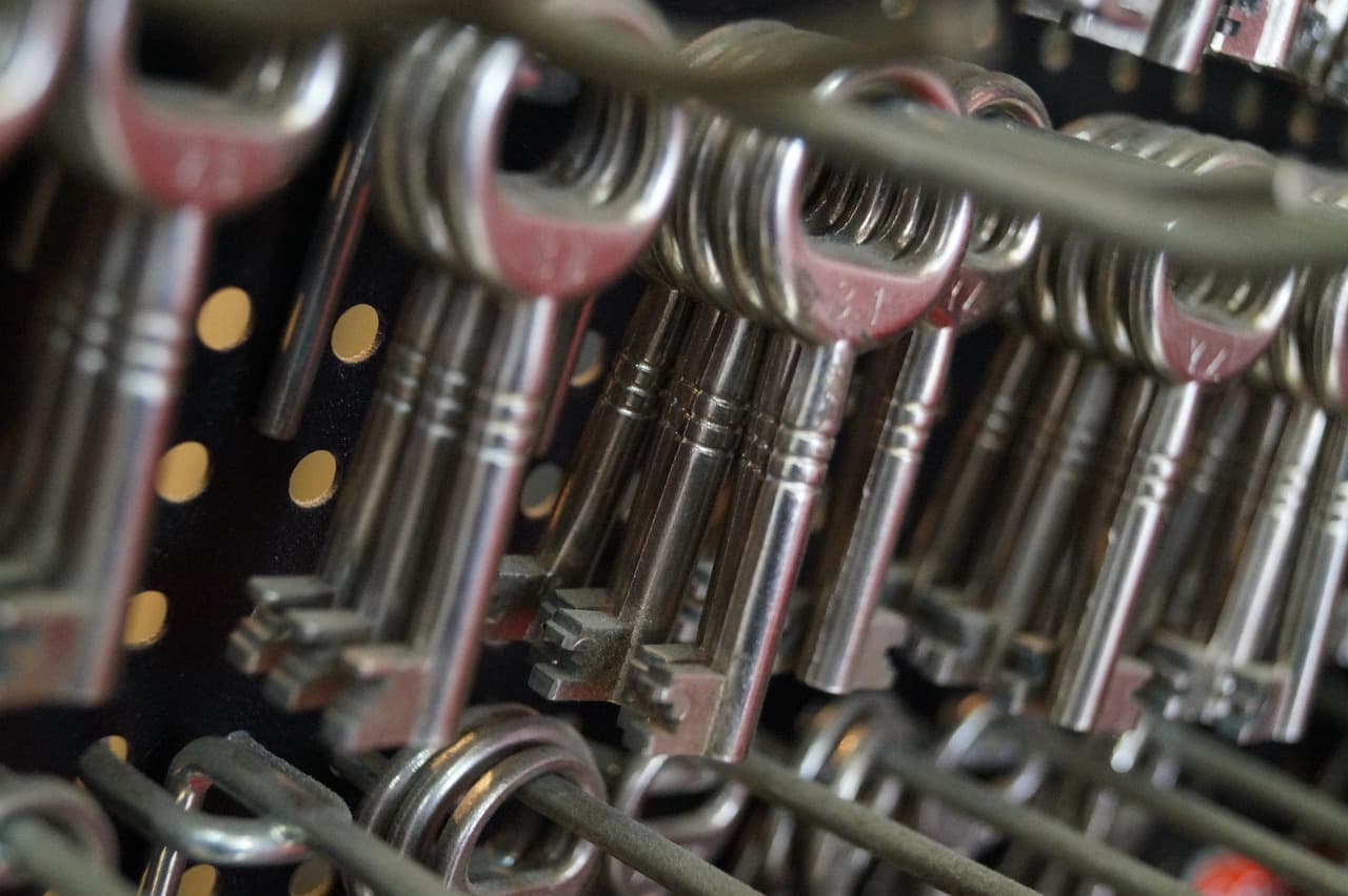 Rows of key blanks hanging on the rack behind a key-cutting counter